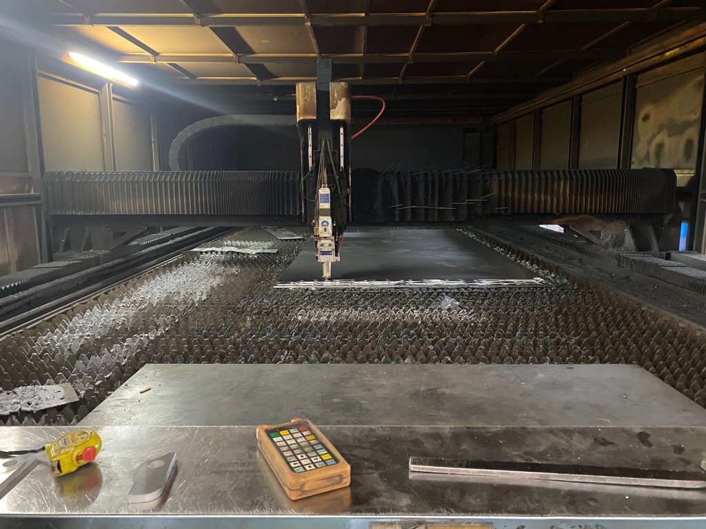 CNC laser cutting machine processing metal sheet for heavy-duty truck accessory manufacturing