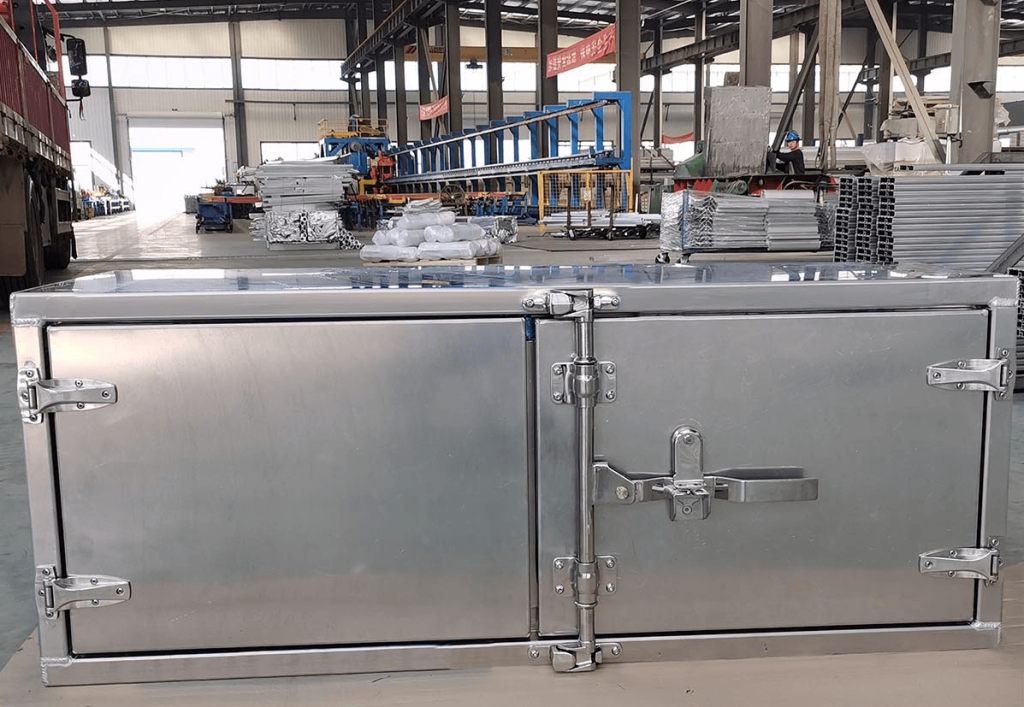 Heavy-duty aluminum truck tool box with reinforced hinges and locking latch manufactured in industrial workshop