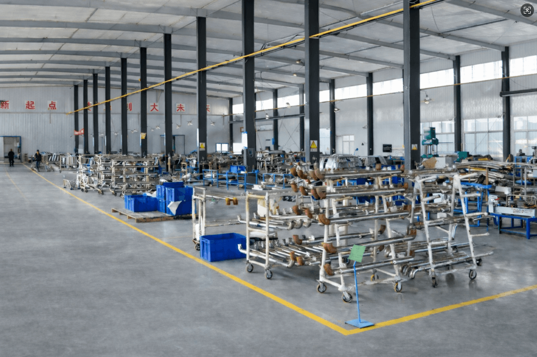 Heavy-duty truck accessories manufacturing workshop with organized production lines, stainless steel components, grey factory floor and yellow safety markings