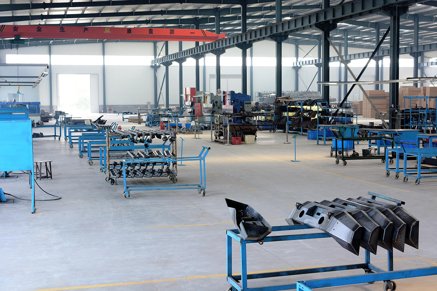 Heavy-duty truck accessory manufacturing workshop with welded steel components and assembly stations