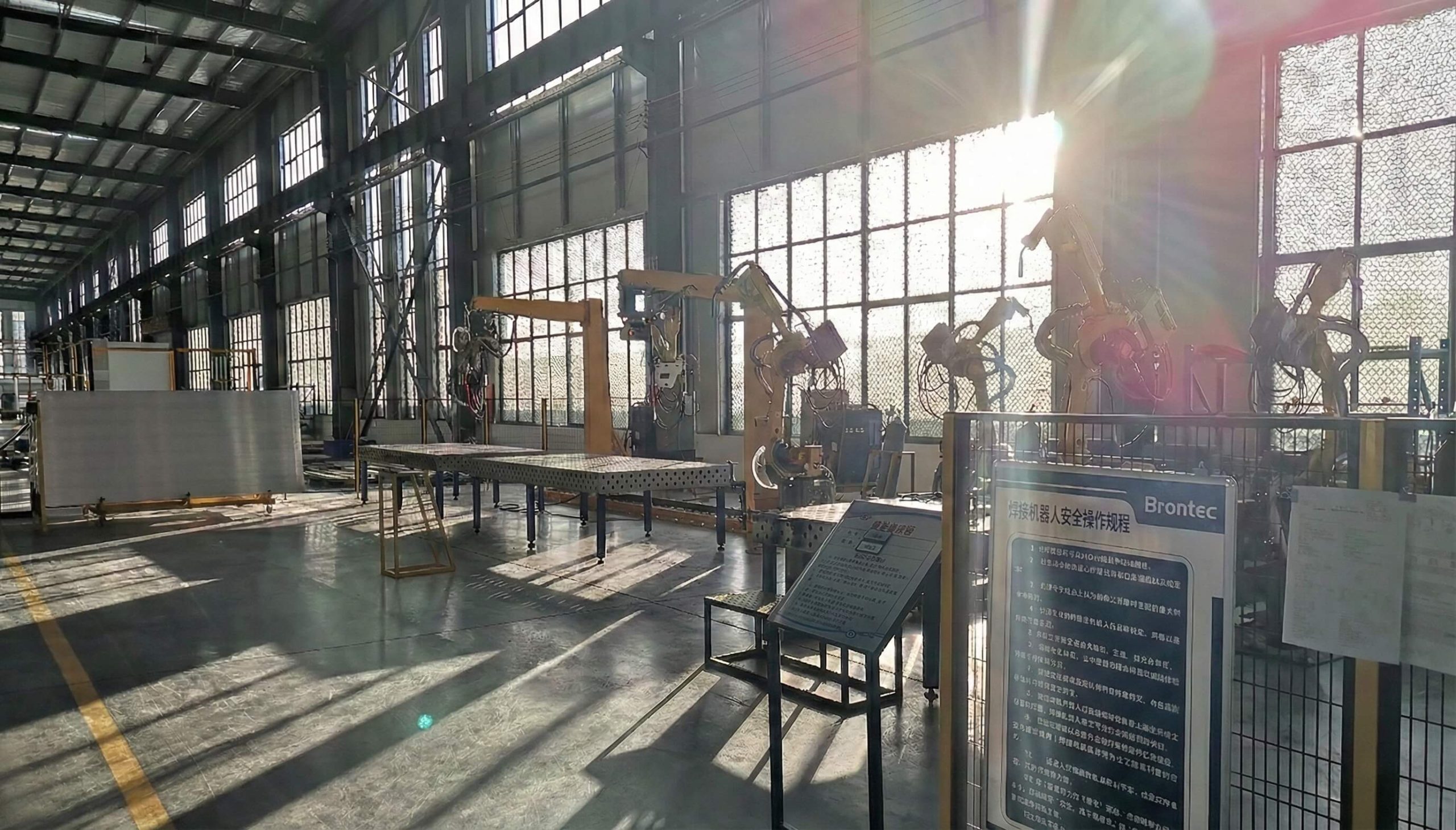 Heavy-duty truck accessories manufacturing workshop with robotic welding arms and automated production lines inside a large-scale industrial factory