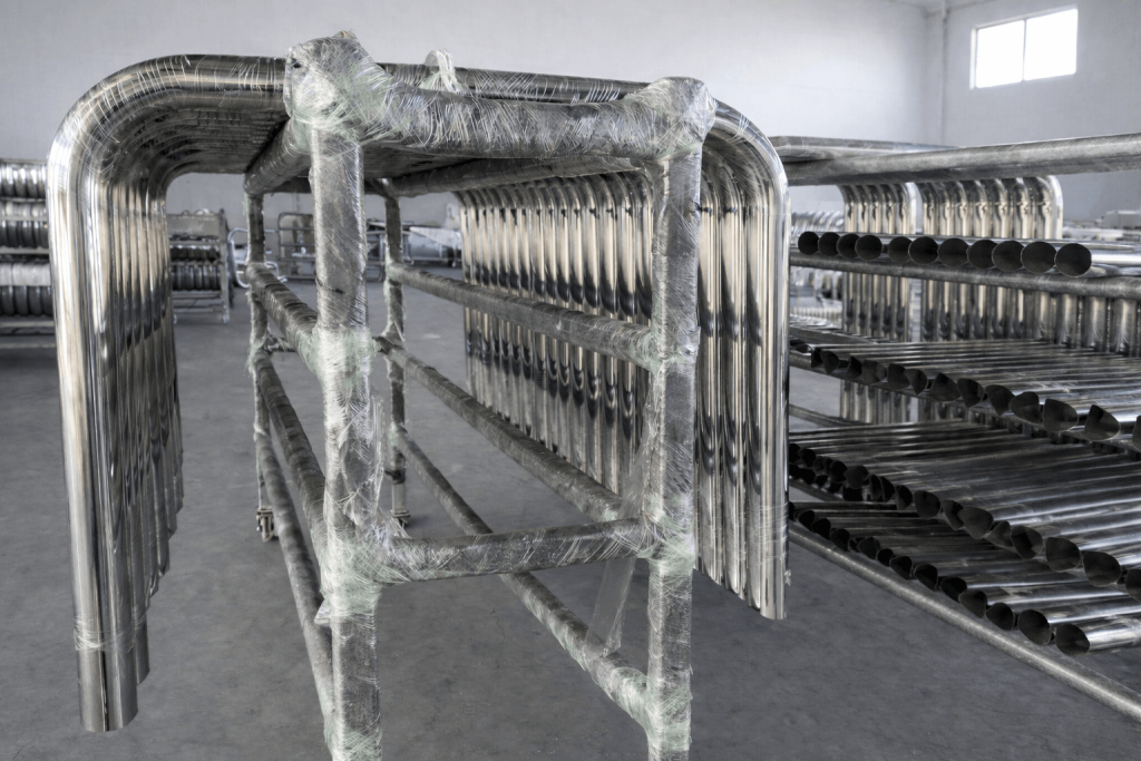 Stainless steel tubular components for heavy-duty truck bumpers staged on storage rack