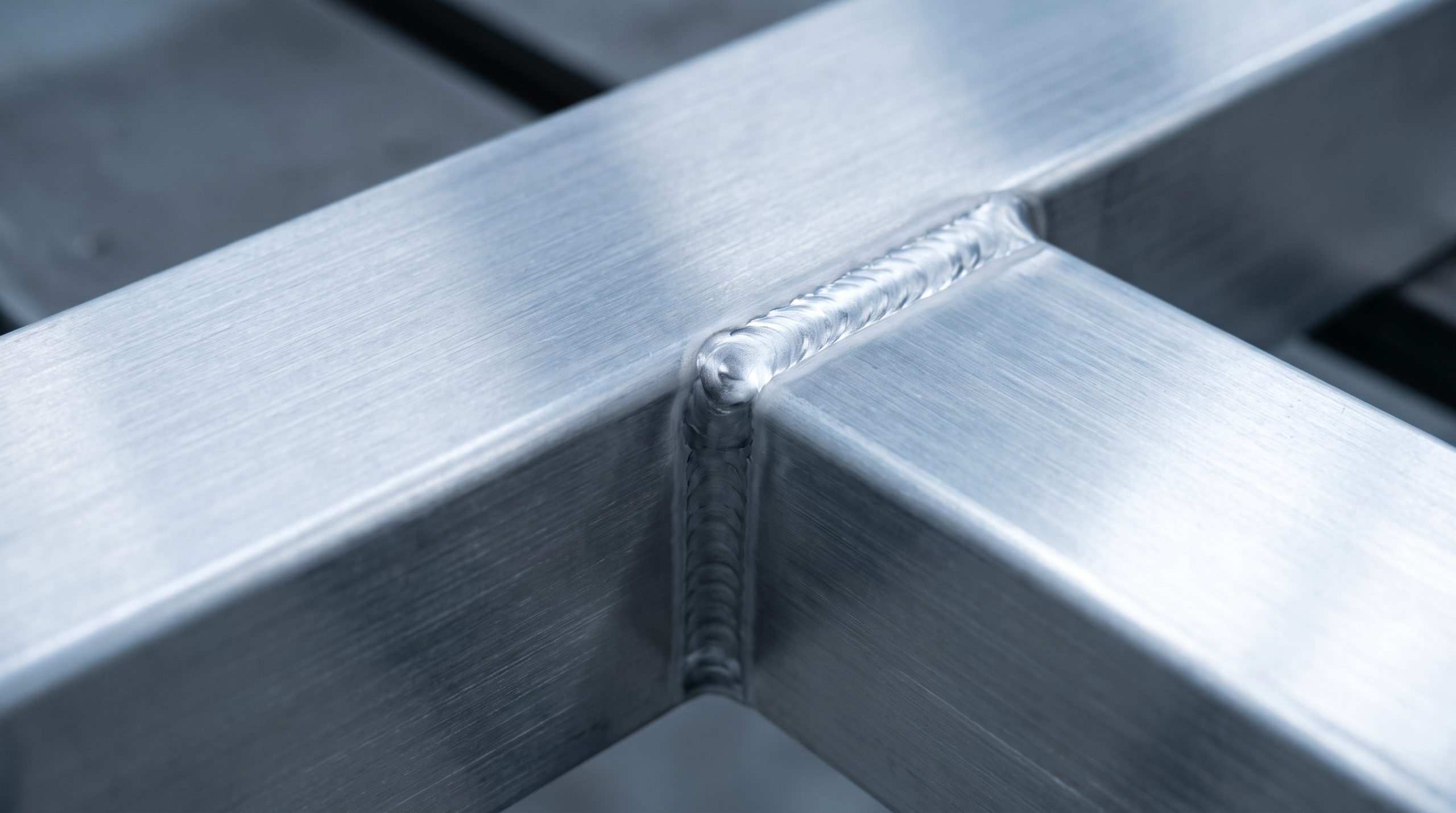 Aluminum alloy weld close up on industrial bumper component