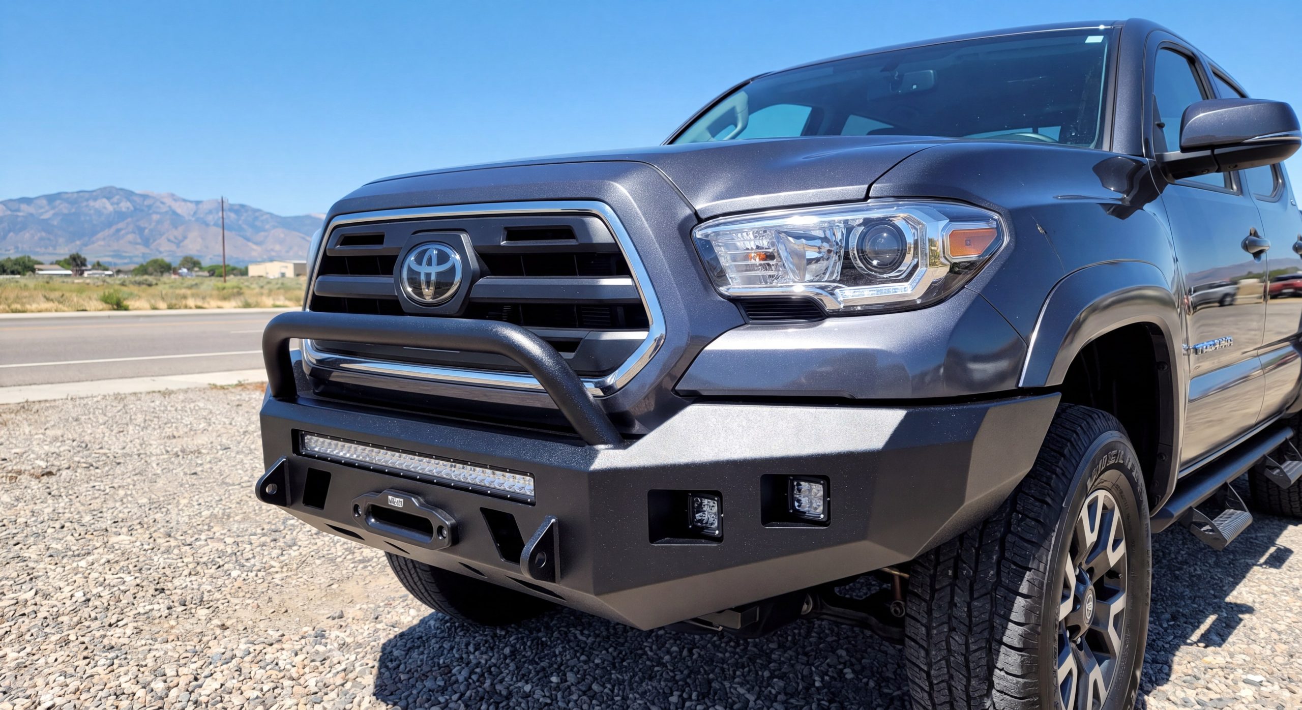 Black steel heavy duty truck bumper installed close up